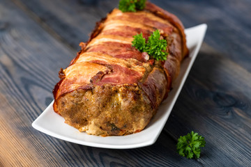 baked roulade of minced meat surrounded by bacon