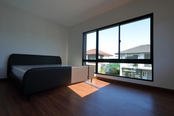 empty modern bedroom with wood laminate floor in residential house