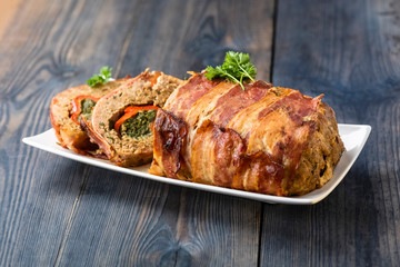 baked roulade of minced meat surrounded by bacon