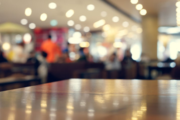 wooden table empty of display in cafe with luxury light decoration