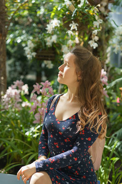 Woman dress in a botanical garden. Lifestyle girl photo