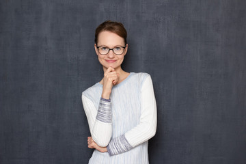 Portrait of happy joyful young woman touching chin with hand