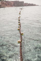 line of buoys at sea