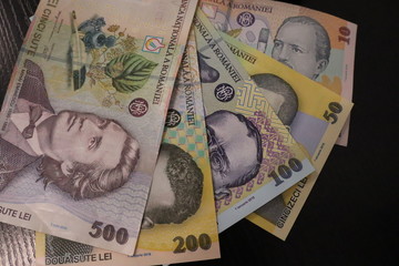 Romanian banknotes on black background