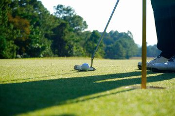 Obraz premium Golfer playing golf in beautiful golf course in the evening golf course with sunshine