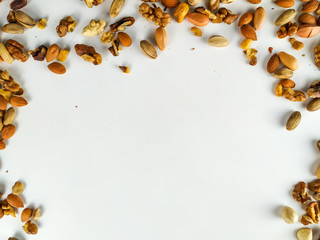 Healthy and nutritious organic nut mix presenting a healthy diet out on the corners of the image forming a frame with empty white space underneath