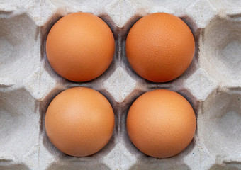 Fresh chicken eggs placed on a paper egg tray. Concept of high protein food, components of healthy food.