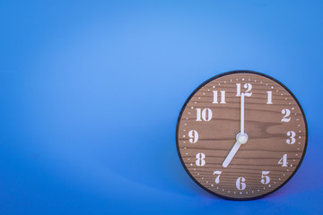 The clock at seven o'clock in the blue background