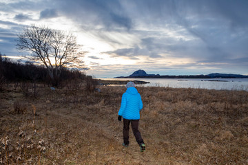 Woman happy walking at seashore in Northern Norway