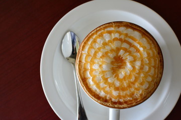 Hot coffee of Cappuccino with latte art on  wooden table background. Top view with copy space for text or objects.