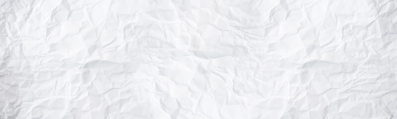 wide panorama white and gray crumpled paper texture background. crush paper so that it becomes...