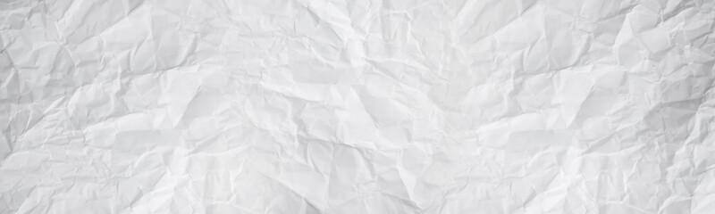 wide panorama white and gray crumpled paper texture background. crush paper so that it becomes creased and wrinkled.
