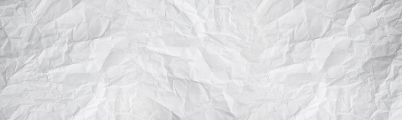 wide panorama white and gray crumpled paper texture background. crush paper so that it becomes...