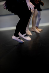 Fototapeta na wymiar Black Tights and pink ballet shoes jumping on dance floor