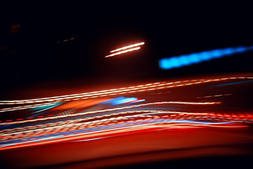 traces of headlights glow / blurred background nocturnal traces of light, texture of a night city