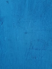 close-up of a decorative wall, with bokeh effect and characteristic rough porous texture, abstract dark and light stains