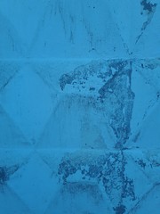 close-up of a decorative wall, with bokeh effect and characteristic rough porous texture, abstract dark and light stains