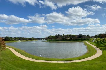 landscape with lake and blue sky and walking path