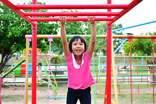 Happy child girl playing at playground.