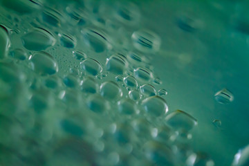 macro close-up photo of condensed water drops on transparent clear glass surface with extreme depth creating a  translucent and abstract pattern and effervescent and freshness copy space background