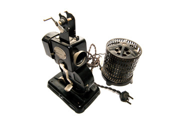 first film projector of domestic film that was commercialized on white background. Reproduced 9.5mm silent movie tapes, which were stored on metal reels