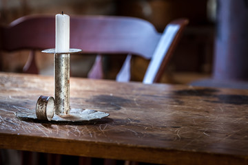 Beautiful vintage candle on old wooden table.