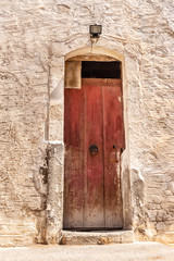 Clay wall with old wooden door