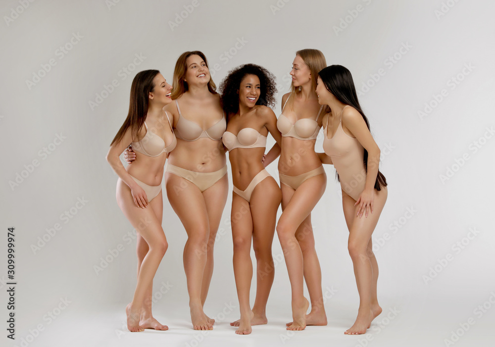 Wall mural group of women with different body types in underwear on light background