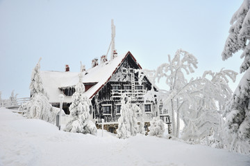 Old house in hoarfrost on frosty winter day, northern slope of Jizera Mountains,  Swieradow Zdroj...