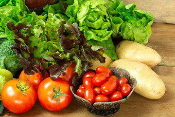 Selected fresh vegetables for salad and meals on wooden table. Healthy eating and diet food.