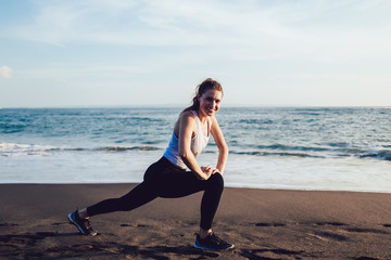 Fototapeta na wymiar Healthy joyful woman stretching at seaside