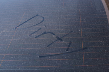Close-Up Of Text On Dirty Windshield