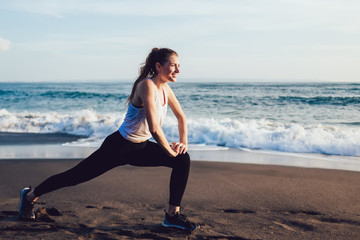 Fototapeta na wymiar Healthy inspired woman stretching at seaside