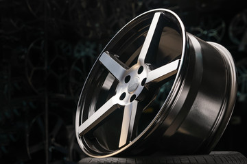 cast aluminum disc alloy wheel modern, close-up on black background, spokes and rim