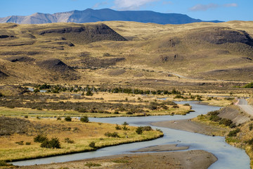 A river with pure water finds a way through the arid landscape near Torres del Paine in Chile. 