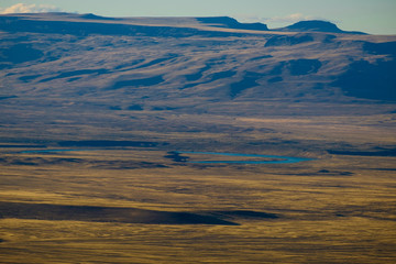 A river curbs through a desolate desert near El Calafate, Argentina. This is a landscape you can only find in the valleys of Patagonia.