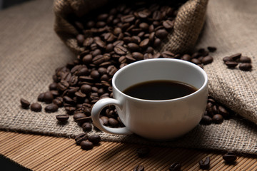 Coffee. A cup of espresso and coffee beans in a tourniquet bag. Beautiful still life.