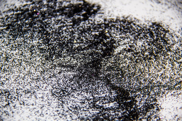 A black glitter on the white background