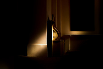 Empty wooden confessional in the old church in the sunlights