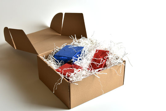 Parcel with gift boxes inside on a white table