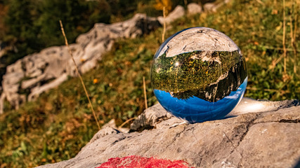 Crystal ball alpine autumn or indian summer landscape shot at the famous Kampenwand, Aschau im Chiemgau, Bavaria, Germany