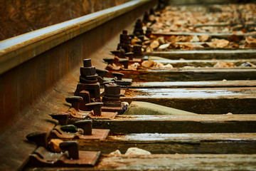 Railway track and sleepers close-up, backlight,sleepers and rails closeup