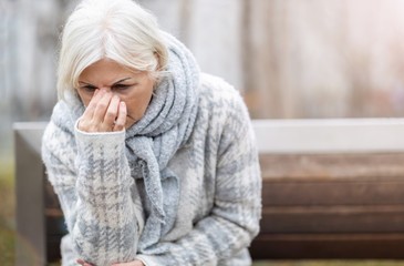 Senior woman suffering from a headache 
