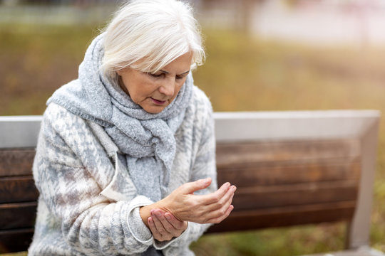 Senior Woman With Arthritis Rubbing Hands