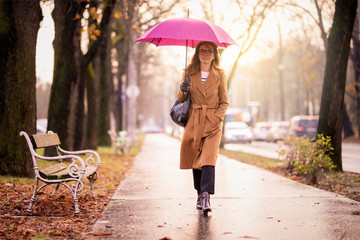 Woman walking on the city on a rainy day
