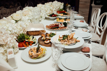 Elegant and luxurious event arrangement. Wedding. Decorated catering banquet table. Food for party. Delicious cuisine menu in tasty food restaurant. Table for banquets, weddings, partie
