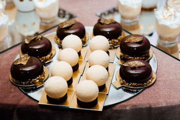 Wedding decoration with pastel colored cupcakes, meringues, muffins and macaroons. Elegant and luxurious event arrangement. Wedding dessert with macaroons