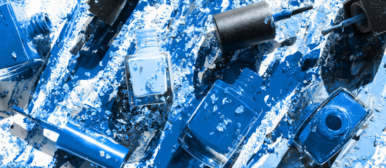Colorful nail lacquer blue color ads, nail polish splatter on white background