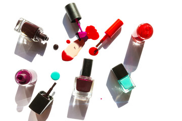 Obraz premium Colorful nail lacquer ads, nail polish splatter on white background