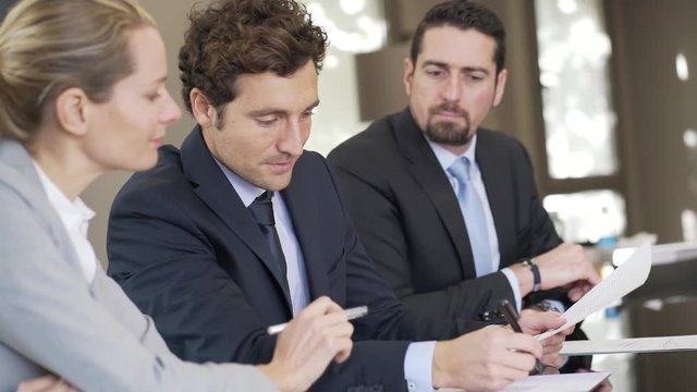 Business people negotiating commercial contract